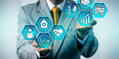 An image of a man in a business suit juggling icons representing various factors in healthcare management.